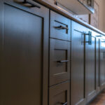 Beautiful,Cabinetry,With,Black,Handles,And,Drawers,Under,White,Countertop