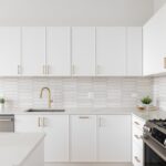 A,Beautiful,Kitchen,Detail,With,White,Cabinets,,A,Gold,Faucet,