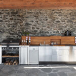 House,,Modern,Kitchen,With,Barbecue,On,The,Veranda